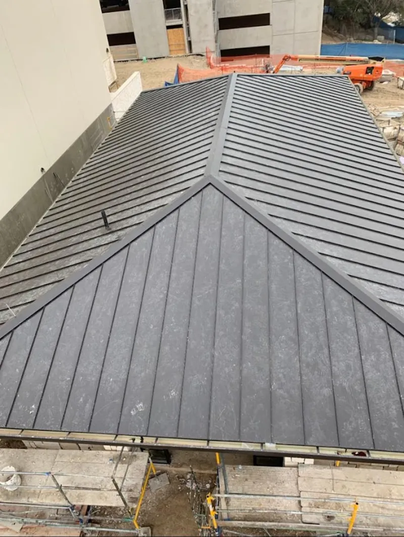Commercial metal roof construction with crane equipment in Yreka