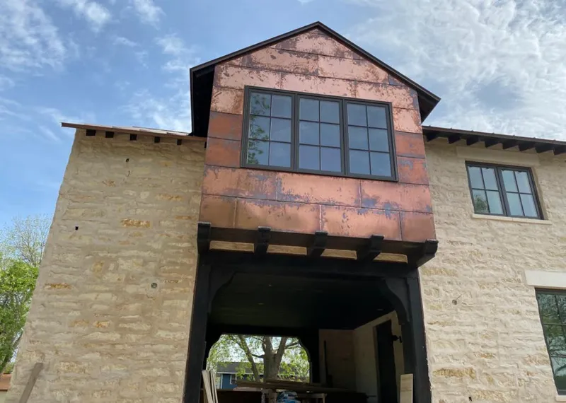Copper metal panel facade on a stone building for Metal Roof Coating in Yreka